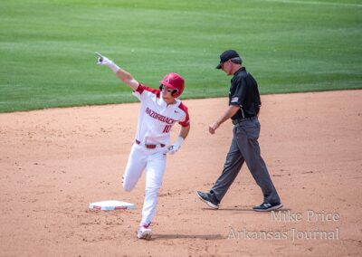 Arkansas Razorbacks Baseball player rounding bases.